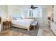 Bedroom featuring neutral tones, a decorative ceiling fan, and plantation shutters at 5880 Midnight Pass Rd # 207, Sarasota, FL 34242