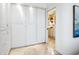 Walk-in closet with built-in cabinets offering plenty of storage, and a view of the bathroom at 5880 Midnight Pass Rd # 207, Sarasota, FL 34242