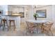 Cozy dining area with seating for four, built-in bar area, and stylish decor at 5880 Midnight Pass Rd # 207, Sarasota, FL 34242