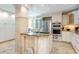 Gourmet kitchen with granite countertops, stainless steel appliances, and a center island with a sink at 5880 Midnight Pass Rd # 207, Sarasota, FL 34242
