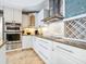 Modern kitchen featuring white cabinetry, stainless steel appliances, and granite countertops at 5880 Midnight Pass Rd # 207, Sarasota, FL 34242