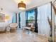 Bright sitting area by large sliding windows that let in plenty of natural light and offer glimpses of tropical plants at 5880 Midnight Pass Rd # 207, Sarasota, FL 34242