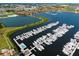Gorgeous aerial view of a marina with lush greenery and waterfront residences in the background at 610 Riviera Dunes Way # 503, Palmetto, FL 34221