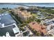 Beautiful aerial view of yellow condominium buildings, a marina, pool, tennis court, and the waterfront at 610 Riviera Dunes Way # 503, Palmetto, FL 34221
