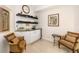 Stylish bar area with wine storage, comfortable seating, and natural light from the window at 610 Riviera Dunes Way # 503, Palmetto, FL 34221