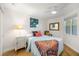 Cozy bedroom featuring hardwood floors, a ceiling fan, colorful decor and a sunny window at 610 Riviera Dunes Way # 503, Palmetto, FL 34221