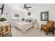 Cozy bedroom with a ceiling fan, a water view, and warm, neutral tones at 610 Riviera Dunes Way # 503, Palmetto, FL 34221