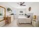 Bright bedroom with an ensuite bathroom, lots of natural light, and a decorative mirror at 610 Riviera Dunes Way # 503, Palmetto, FL 34221