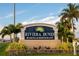Riviera Dunes Marina & Restaurant sign with palm trees, flowers, and well-manicured landscaping at 610 Riviera Dunes Way # 503, Palmetto, FL 34221