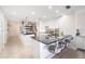 Bright kitchen featuring white cabinets, a marble island with barstool seating, and seamless flow into the hallway at 610 Riviera Dunes Way # 503, Palmetto, FL 34221