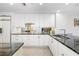 Bright kitchen with white cabinets, granite countertops, stainless steel appliances and sink at 610 Riviera Dunes Way # 503, Palmetto, FL 34221