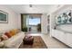 Bright living room with sliding doors to balcony, scenic views and modern furnishings at 610 Riviera Dunes Way # 503, Palmetto, FL 34221