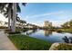 Beautiful pond with a fountain, lush greenery, and palm trees at the community at 610 Riviera Dunes Way # 503, Palmetto, FL 34221