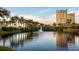Scenic pond at the community, reflecting the surrounding palm trees and buildings at 610 Riviera Dunes Way # 503, Palmetto, FL 34221