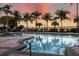 Enjoy the community pool with palm trees and lounge chairs, perfect for relaxation at 610 Riviera Dunes Way # 503, Palmetto, FL 34221