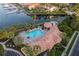 Aerial view showcasing a luxurious community pool, spa, and surrounding lounge area near the marina at 610 Riviera Dunes Way # 503, Palmetto, FL 34221