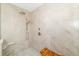 Modern shower with marble tile, rainfall shower head, handheld sprayer, and wooden bench at 610 Riviera Dunes Way # 503, Palmetto, FL 34221