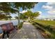 Relaxing view of a path next to the lake in the community at 610 Riviera Dunes Way # 503, Palmetto, FL 34221