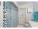 Well-lit bathroom featuring a bathtub with shower curtain, door to outside, and white vanity at 6203 11Th W Ave, Bradenton, FL 34209
