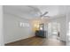 Open bedroom features wood floors, two large windows, and a dresser, leading to another room at 6203 11Th W Ave, Bradenton, FL 34209
