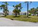 Bright home with a white exterior, arched accents, a two-car garage, and mature shade trees at 6203 11Th W Ave, Bradenton, FL 34209