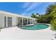 Inviting pool area with covered patio, outdoor dining space, and serene views of the landscaped yard at 6203 11Th W Ave, Bradenton, FL 34209