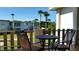 Relaxing balcony with a table and chairs, overlooking lush greenery and nearby buildings at 6300 Flotilla Dr # 108, Holmes Beach, FL 34217