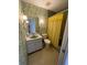 Traditional bathroom with floral wallpaper and yellow accents at 6300 Flotilla Dr # 108, Holmes Beach, FL 34217