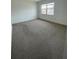 Bedroom with carpet flooring, white walls and a window for natural light at 6300 Flotilla Dr # 108, Holmes Beach, FL 34217