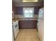 Traditional kitchen with brown wood cabinets, double basin sink and white appliances at 6300 Flotilla Dr # 108, Holmes Beach, FL 34217