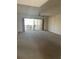 Open living room with sliding glass doors to balcony and neutral carpet at 6300 Flotilla Dr # 108, Holmes Beach, FL 34217