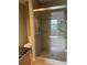 Tiled walk-in shower with glass doors, built-in shelving and chrome fixtures at 6300 Flotilla Dr # 108, Holmes Beach, FL 34217