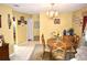 Traditional dining room with wood table, six chairs, chandelier, and decorative accents creating a cozy atmosphere at 6704 Rosemary Dr, Tampa, FL 33625