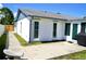 Exterior of home with a concrete patio and walkway, plus fresh white paint, offering a clean and modern look at 6704 Rosemary Dr, Tampa, FL 33625