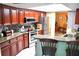 Well-equipped kitchen with wooden cabinetry, granite countertops, stainless steel appliances, and a breakfast bar at 6704 Rosemary Dr, Tampa, FL 33625