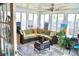 Bright sun room with floor to ceiling windows, tile flooring, and casual furnishings creating a cheerful and versatile space at 6704 Rosemary Dr, Tampa, FL 33625