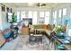 Bright sunroom featuring large windows, neutral colors, and ceiling fan, creating a relaxing and inviting space at 6704 Rosemary Dr, Tampa, FL 33625