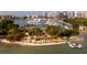 Aerial view showcases waterfront restaurants with colorful umbrellas and boat docks in the bay at 688 Golden Gate Point # 201, Sarasota, FL 34236