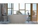 Modern bathroom featuring a standalone tub, elegant fixtures, and serene natural light at 688 Golden Gate Point # 201, Sarasota, FL 34236