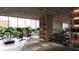 Bright fitness center featuring modern equipment, hardwood floors, and floor to ceiling windows at 688 Golden Gate Point # 201, Sarasota, FL 34236