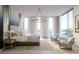 Luxurious main bedroom featuring a comfortable bed, designer chandelier, and stunning water views at 688 Golden Gate Point # 201, Sarasota, FL 34236