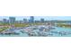Panoramic view of the marina showcasing a multitude of boats docked against a backdrop of city buildings at 688 Golden Gate Point # 201, Sarasota, FL 34236