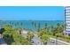 Beautiful view of bay with palm trees lining the street below at 688 Golden Gate Point # 201, Sarasota, FL 34236