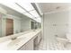 Bathroom featuring double sinks and a large mirror at 7023 Woodside Oaks Cir # 1, Sarasota, FL 34231