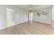Bedroom featuring wood floors, neutral paint, and natural light at 7023 Woodside Oaks Cir # 1, Sarasota, FL 34231