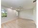 Bright bedroom with wood-look floors, neutral walls, and ceiling fan at 7023 Woodside Oaks Cir # 1, Sarasota, FL 34231
