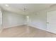 Bedroom with light wood floors, neutral walls, ceiling fan and bathroom access at 7023 Woodside Oaks Cir # 1, Sarasota, FL 34231