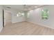 Bright bedroom features wood floors, neutral walls, and natural light at 7023 Woodside Oaks Cir # 1, Sarasota, FL 34231