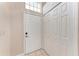 Entryway with tile floors, large closet, and white front door at 7023 Woodside Oaks Cir # 1, Sarasota, FL 34231