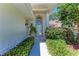 Well-lit doorway with decorative bushes at 7023 Woodside Oaks Cir # 1, Sarasota, FL 34231